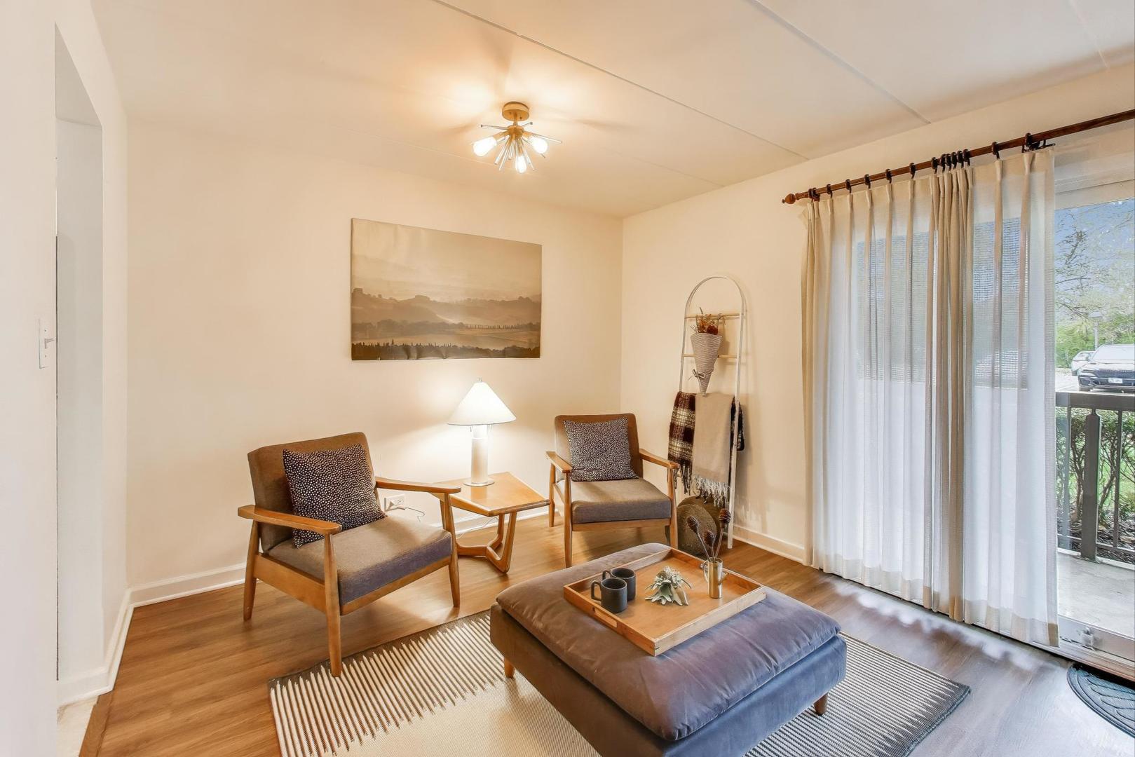 6443 Clarendon Hills Road, Unit 100D Willowbrook, IL 60527 - Photo 6 of 31 a living room with furniture and a window