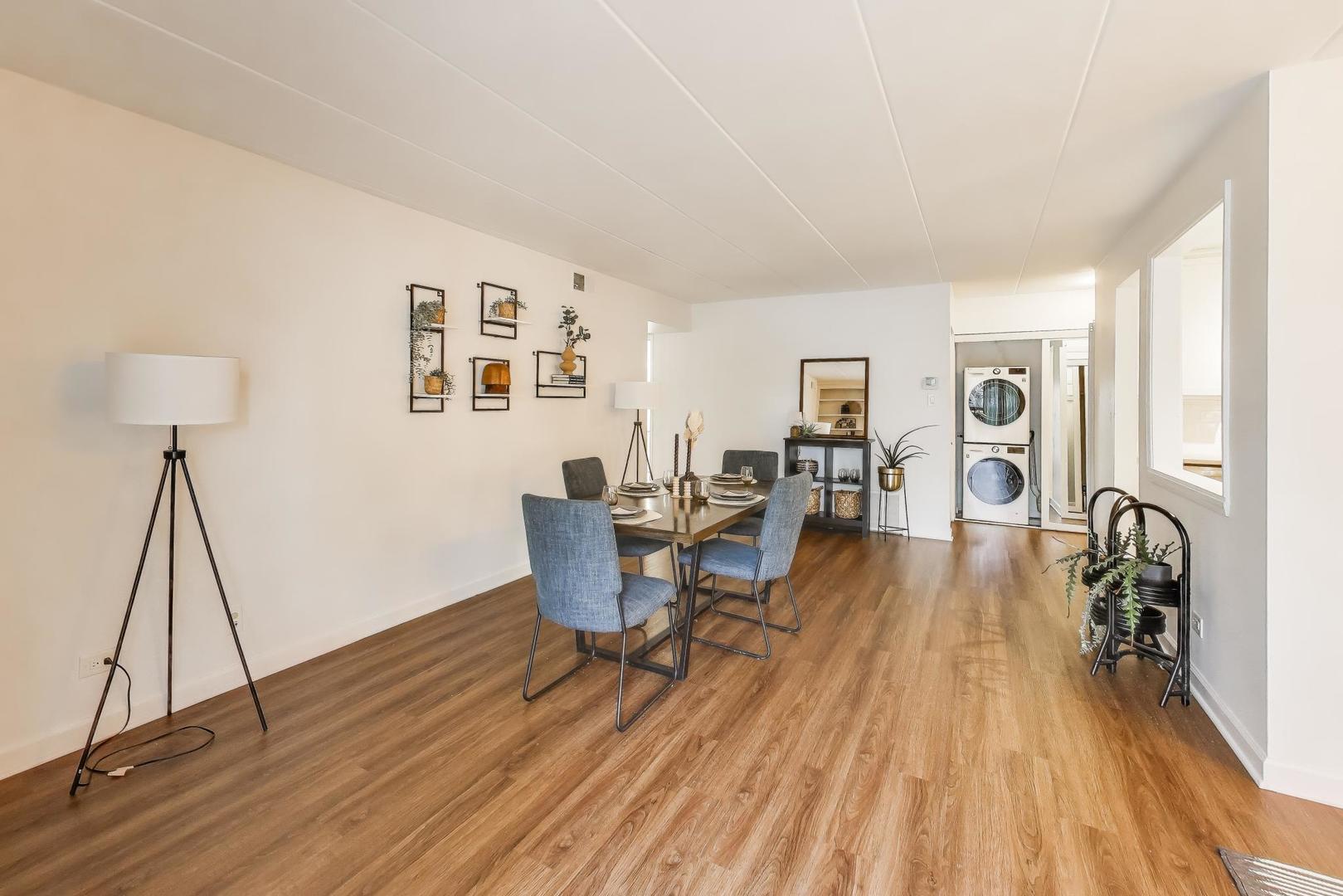 6443 Clarendon Hills Road, Unit 100D Willowbrook, IL 60527 - Photo 7 of 31 a living room with furniture and a wooden floor