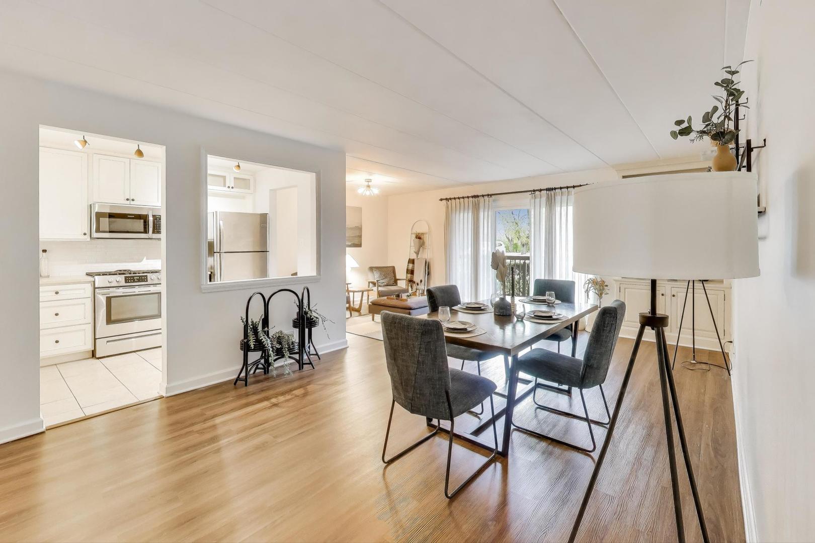 6443 Clarendon Hills Road, Unit 100D Willowbrook, IL 60527 - Photo 8 of 31 a view of a dining room with furniture window and wooden floor