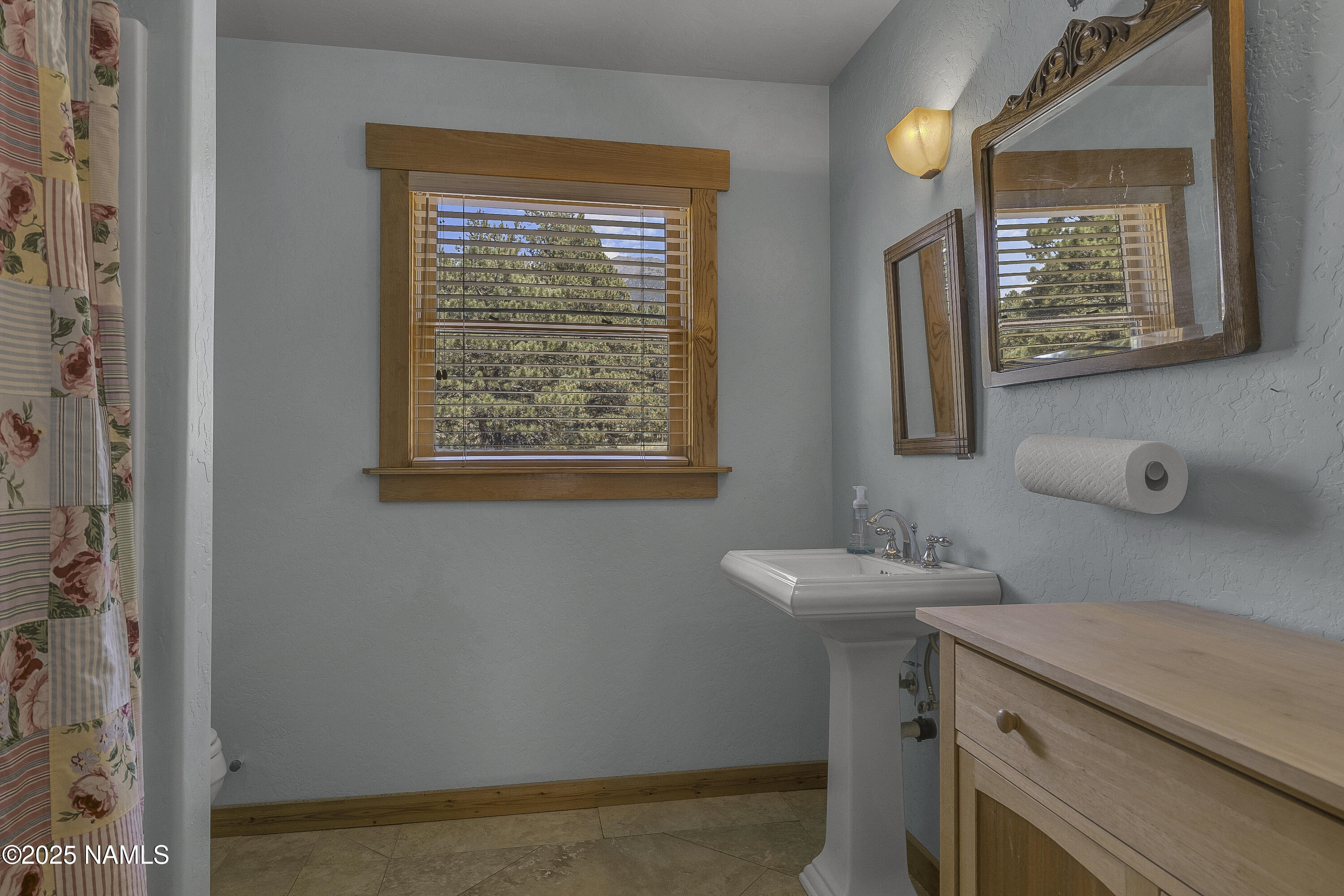13898 Alpenglow Road Flagstaff, AZ 86001 - Photo 13 of 39 a bathroom with a sink a mirror and a window
