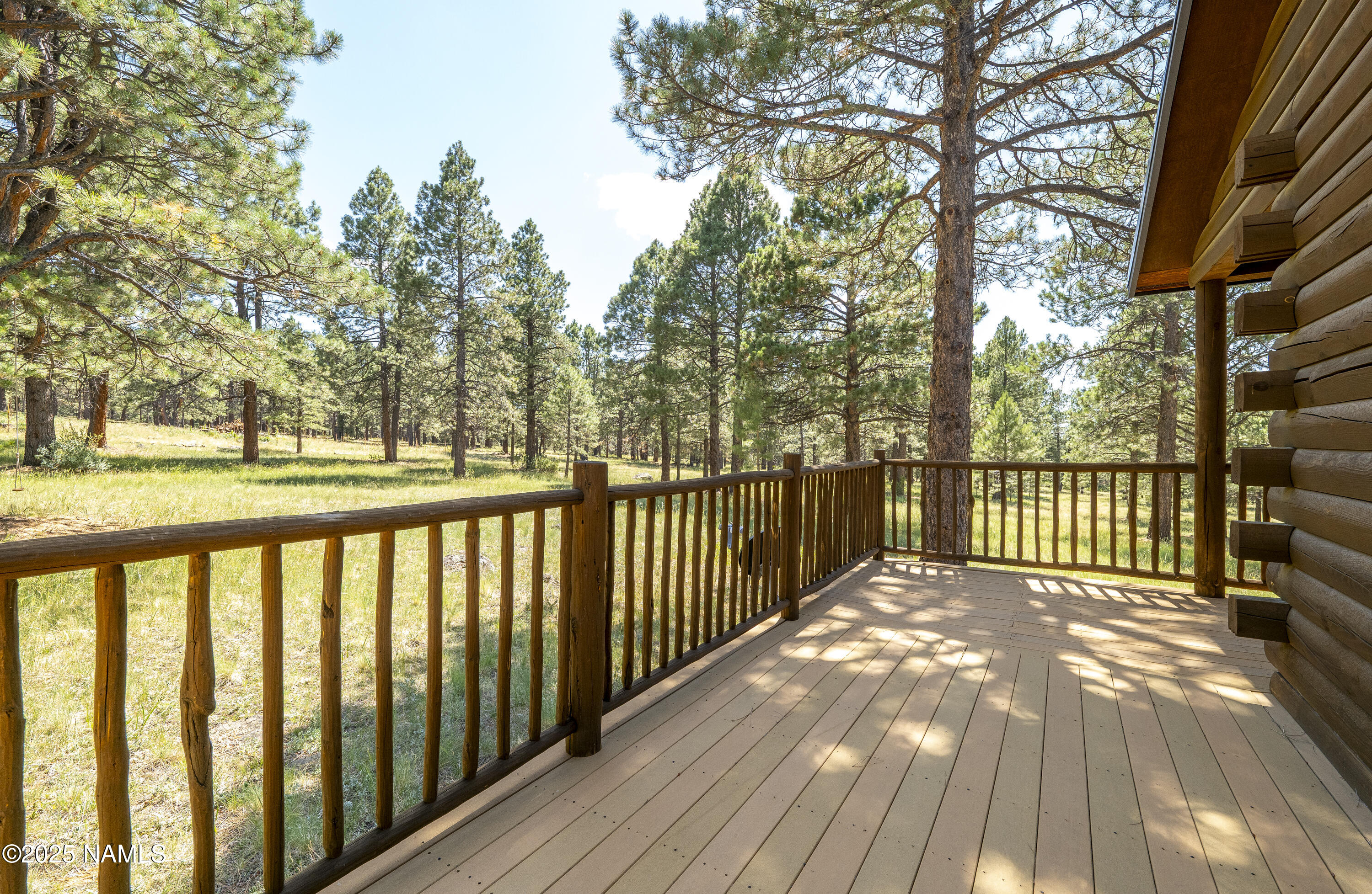13898 Alpenglow Road Flagstaff, AZ 86001 - Photo 21 of 39 a balcony with wooden floor and fence