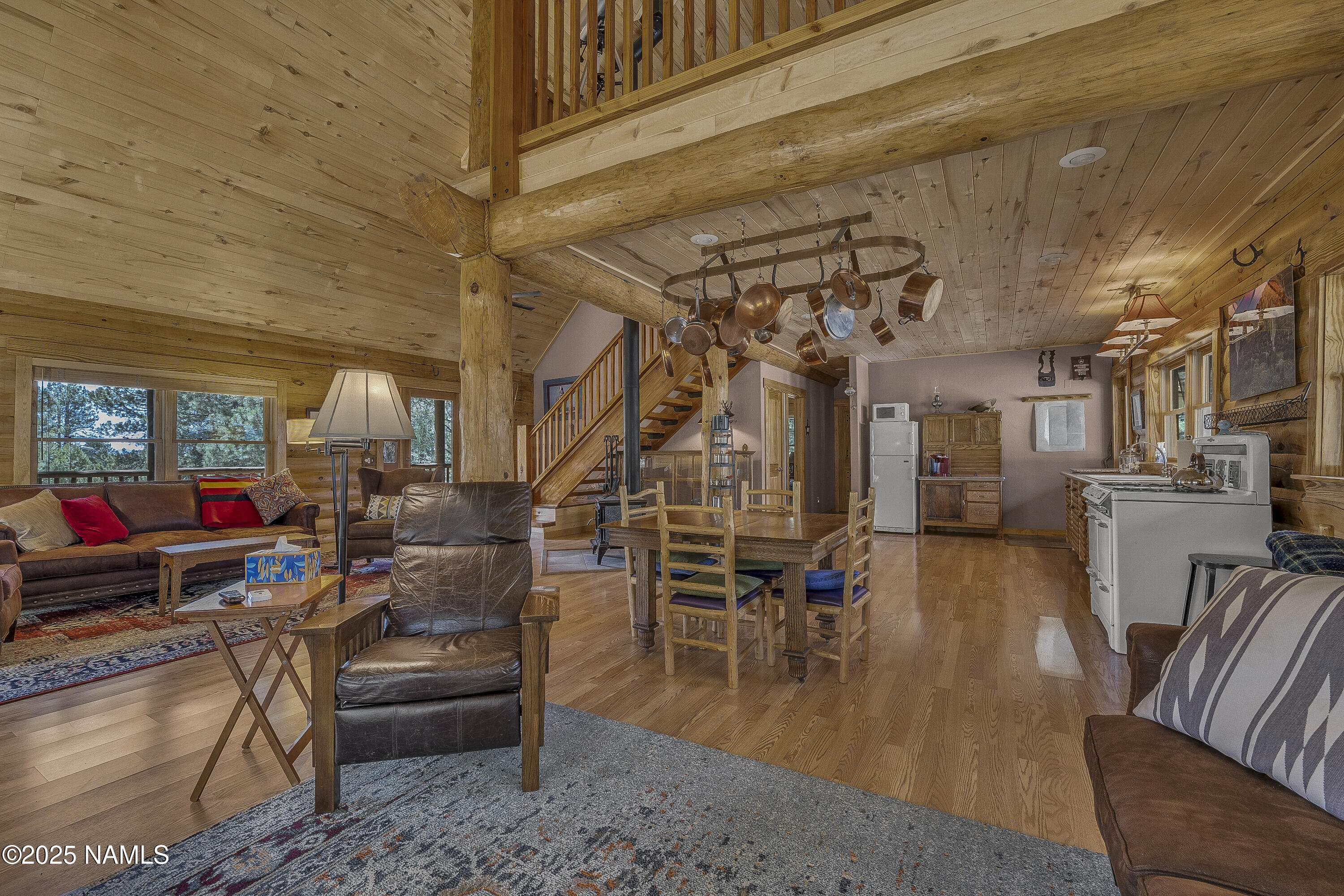 13898 Alpenglow Road Flagstaff, AZ 86001 - Photo 31 of 39 a living room with lots of furniture and a chandelier
