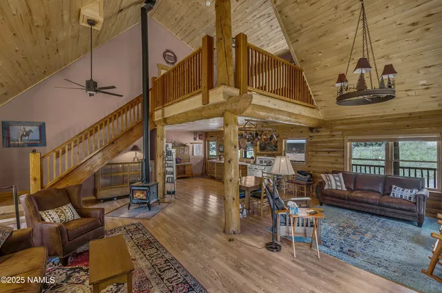 a bedroom with bed and wooden floor