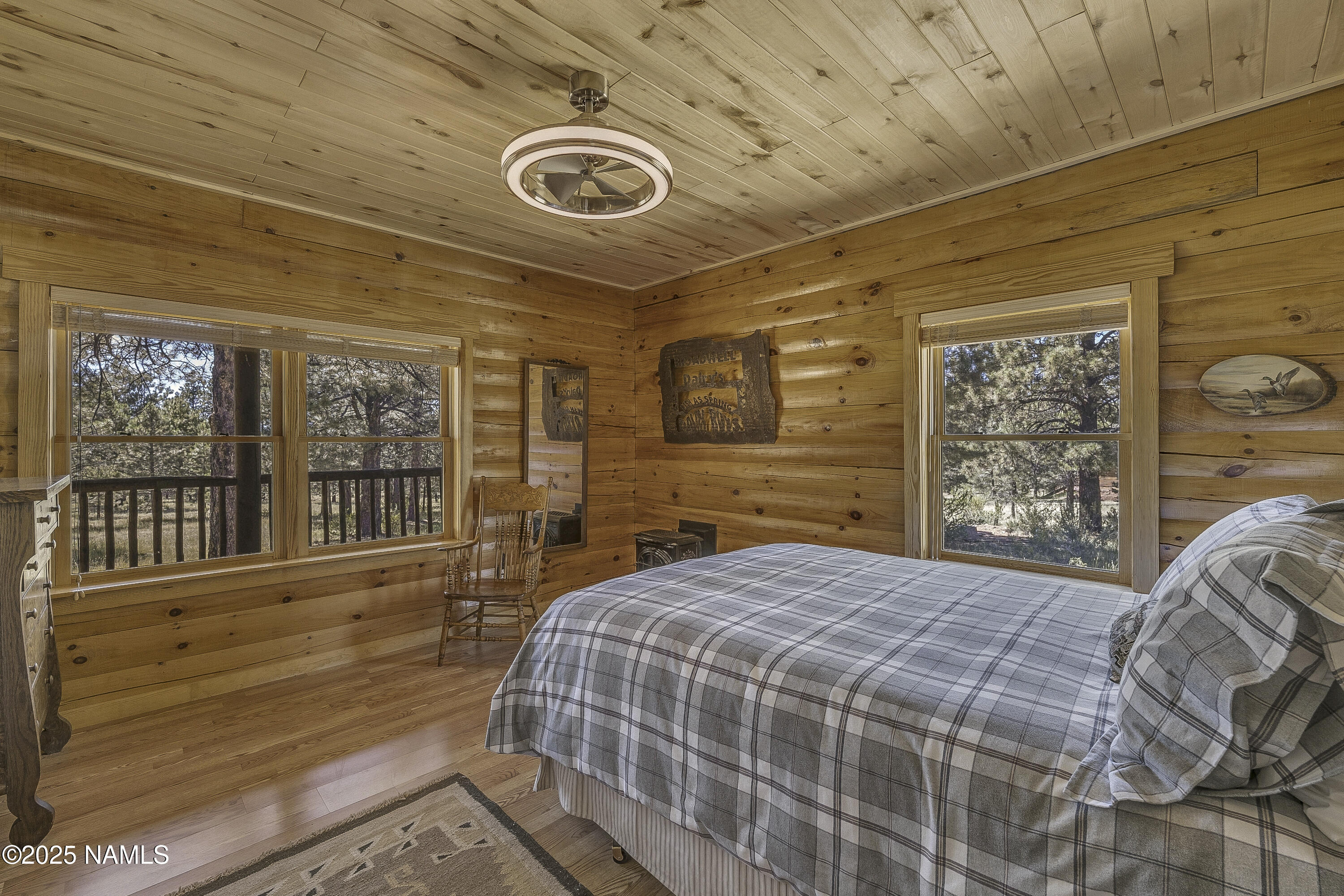 13898 Alpenglow Road Flagstaff, AZ 86001 - Photo 35 of 39 a bedroom with a bed and a large window