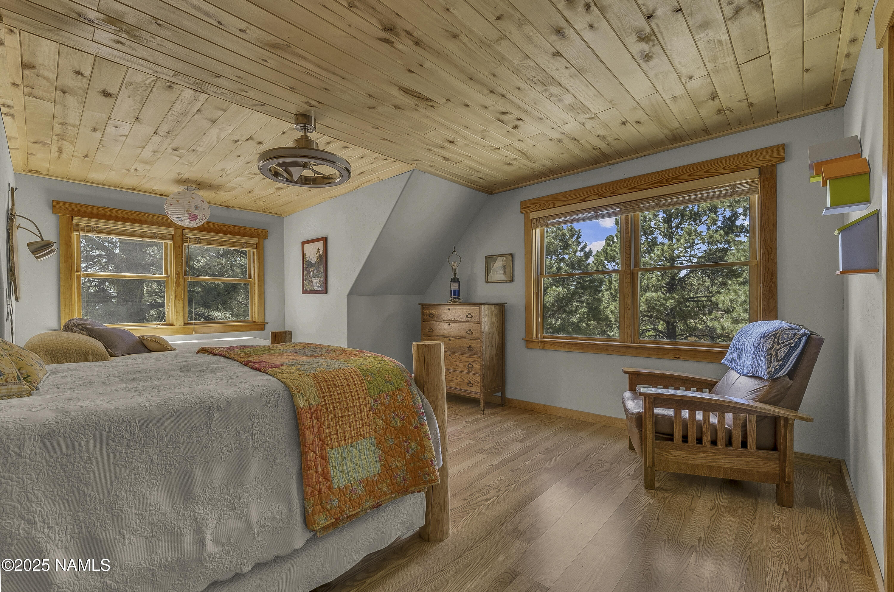 13898 Alpenglow Road Flagstaff, AZ 86001 - Photo 37 of 39 a bedroom with furniture and a large window