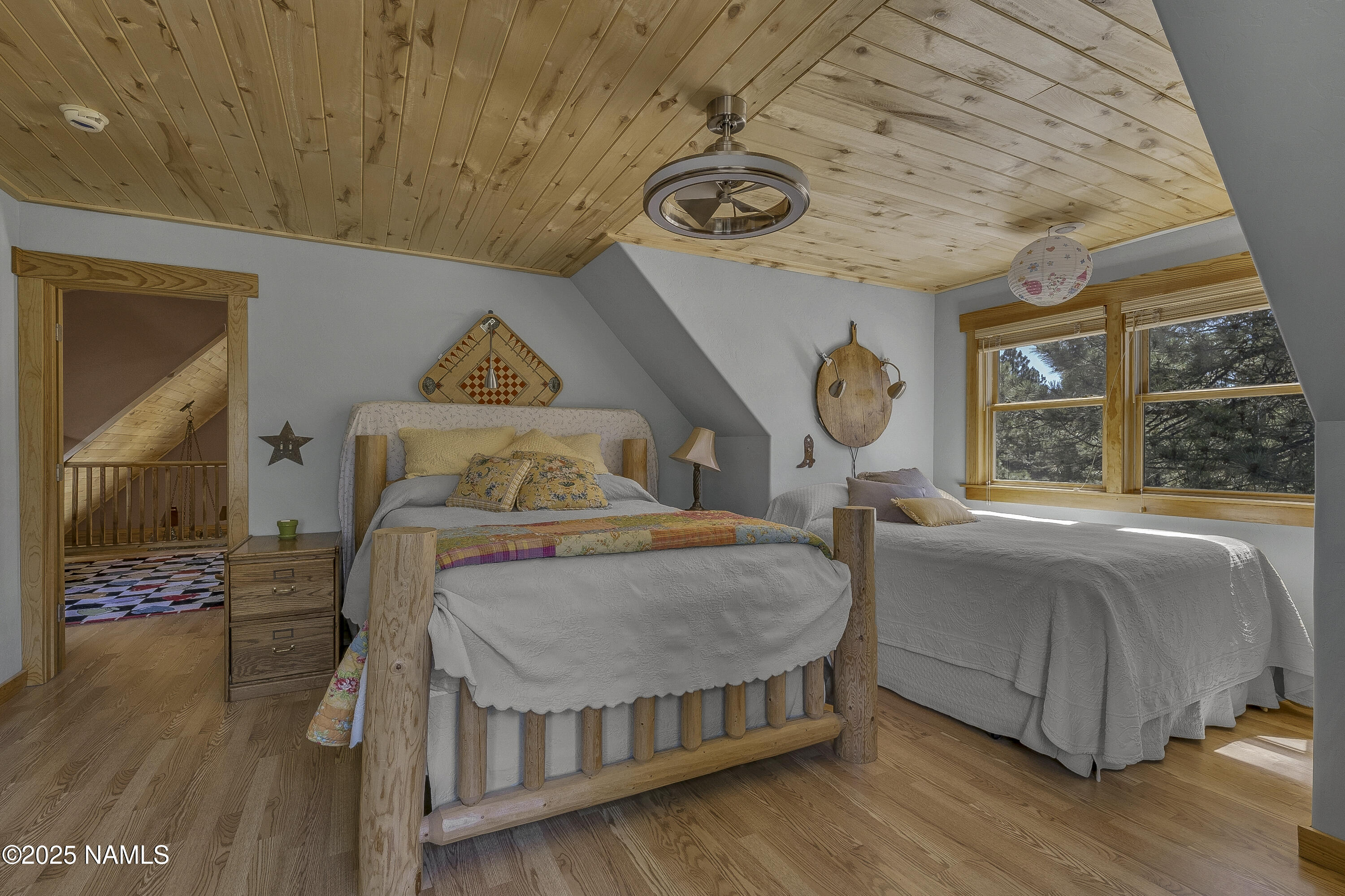 13898 Alpenglow Road Flagstaff, AZ 86001 - Photo 38 of 39 a bedroom with bed and wooden floor