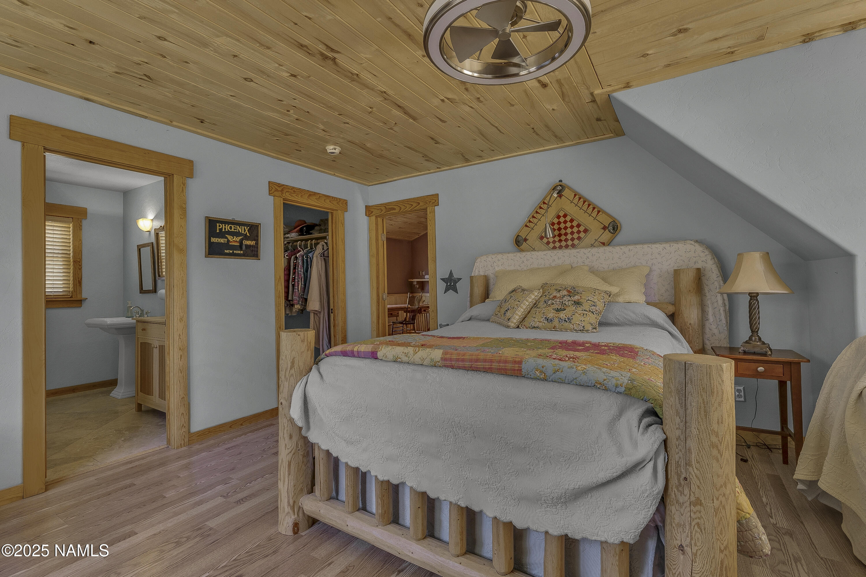 13898 Alpenglow Road Flagstaff, AZ 86001 - Photo 39 of 39 a bedroom with a bed and wooden floor