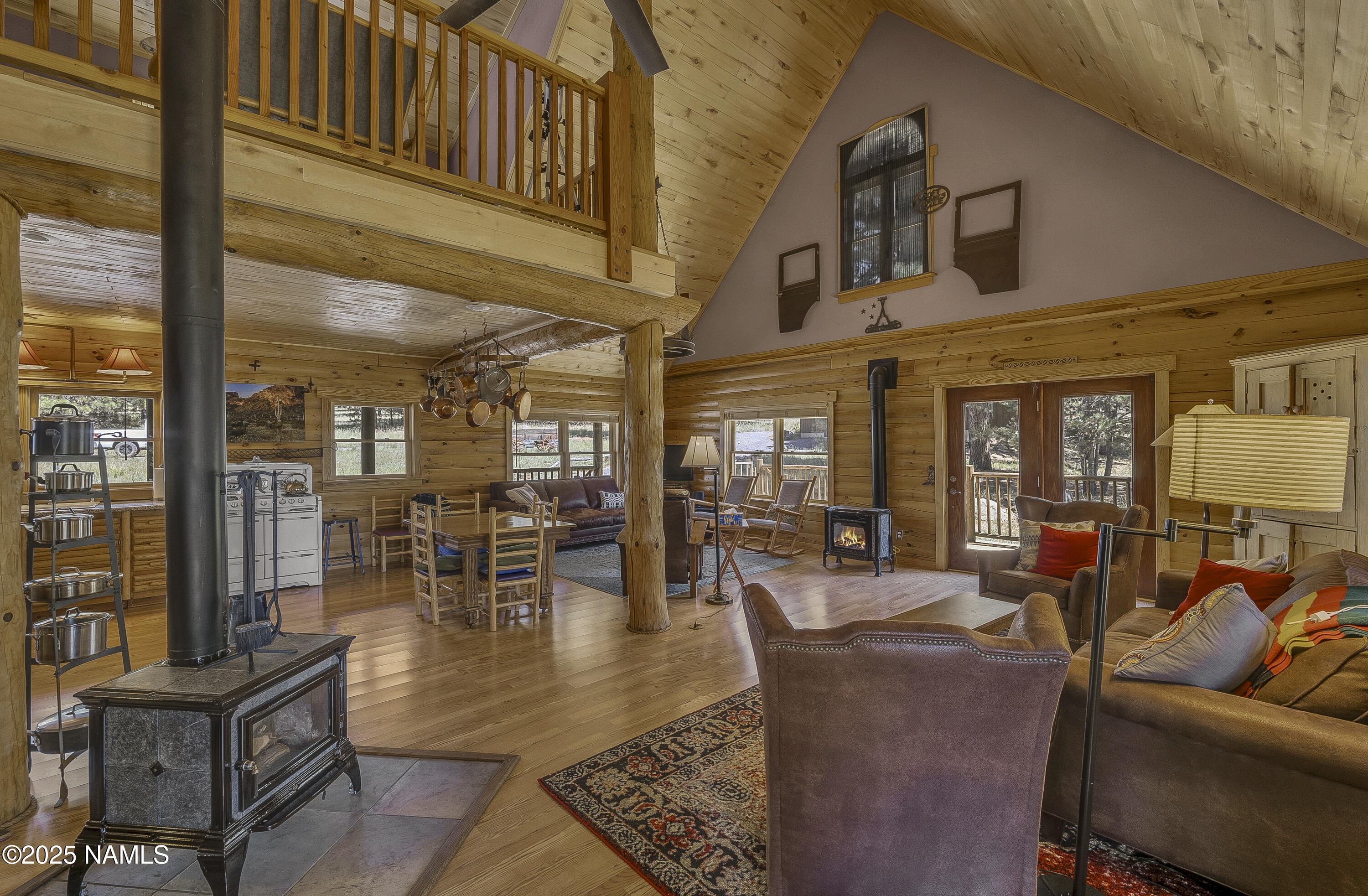 13898 Alpenglow Road Flagstaff, AZ 86001 - Photo 6 of 39 a living room with fireplace furniture and a large window