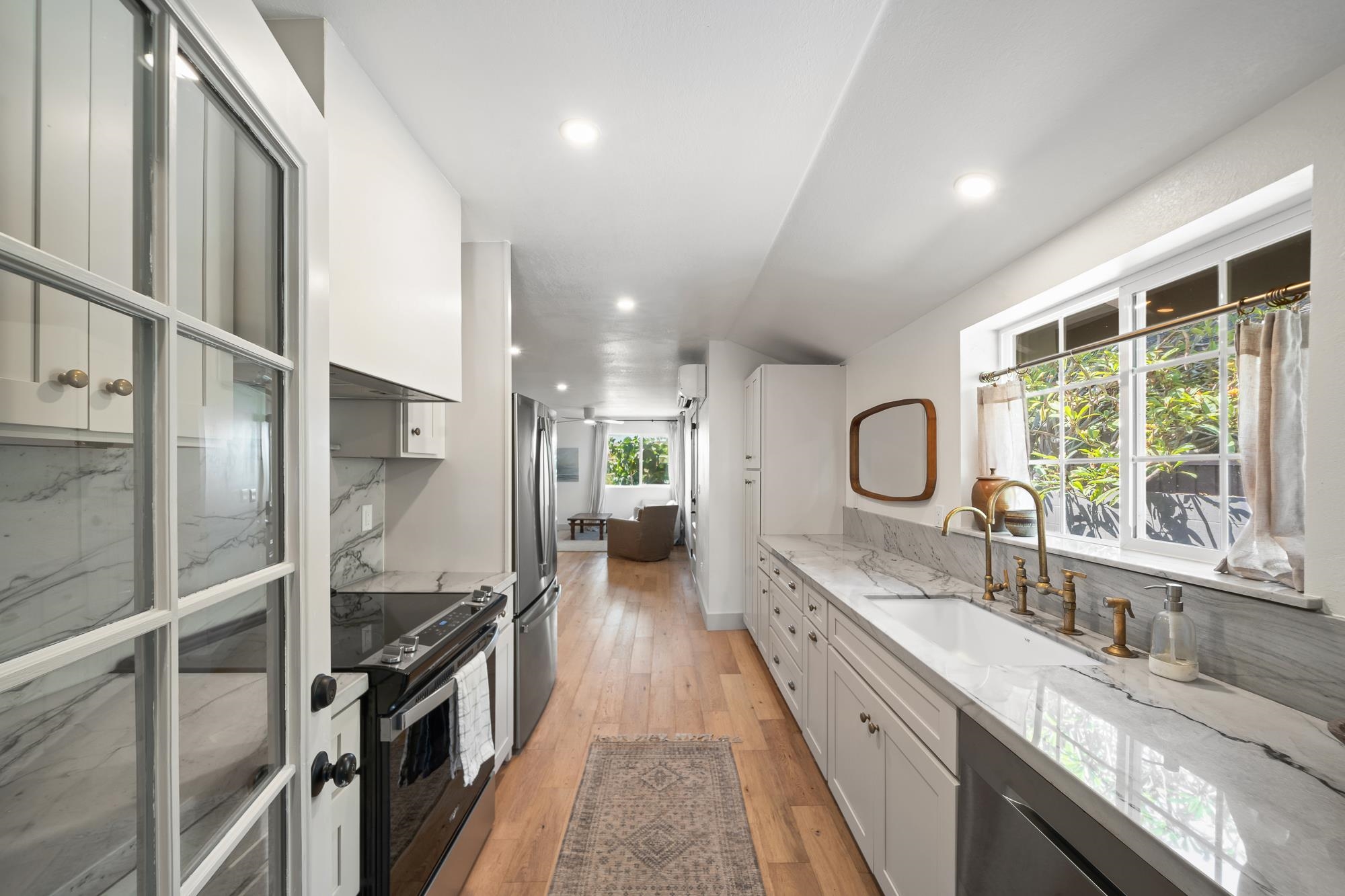 2074 Puuohala Road Wailuku, HI 96793 - Photo 10 of 37 a large kitchen with a large window and stainless steel appliances