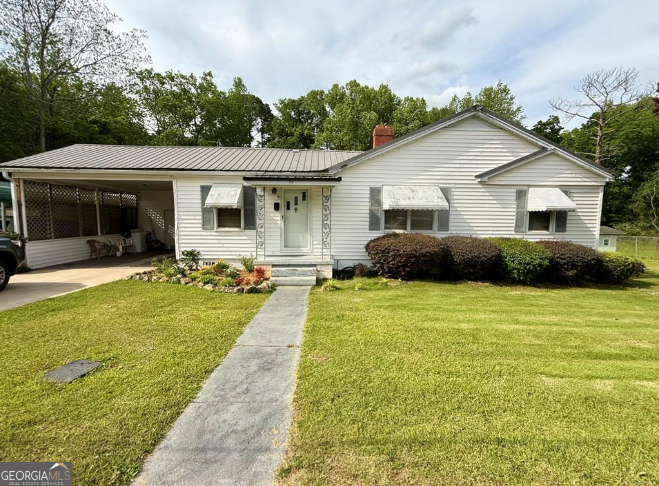 a front view of house with yard and green space
