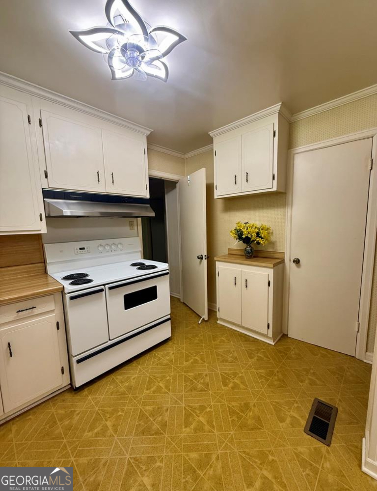93 Arnall Boulevard Blakely, GA 39823 - Photo 17 of 43 a kitchen with a stove cabinets and a refrigerator