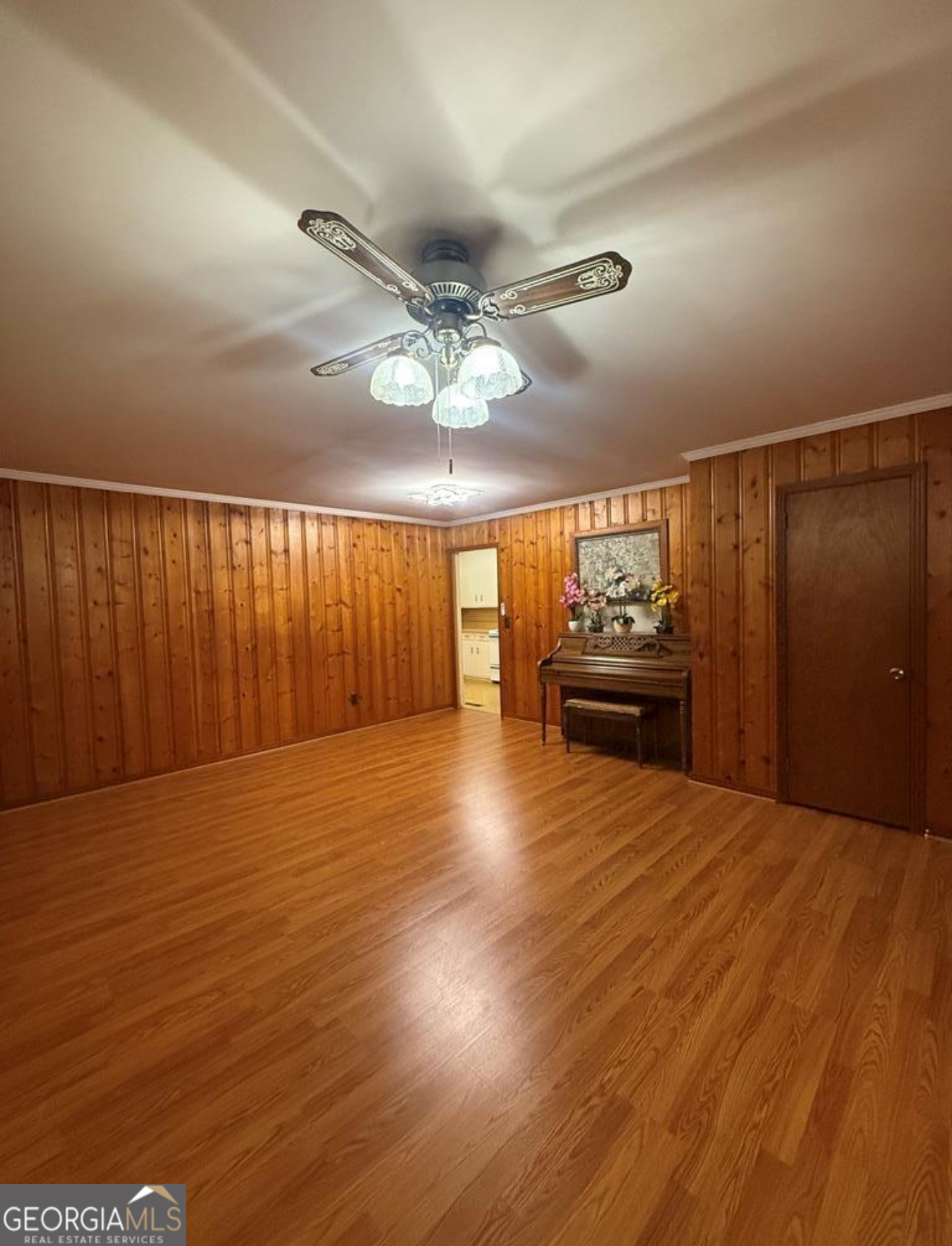 93 Arnall Boulevard Blakely, GA 39823 - Photo 19 of 43 a view of an empty room with wooden floor and a ceiling fan