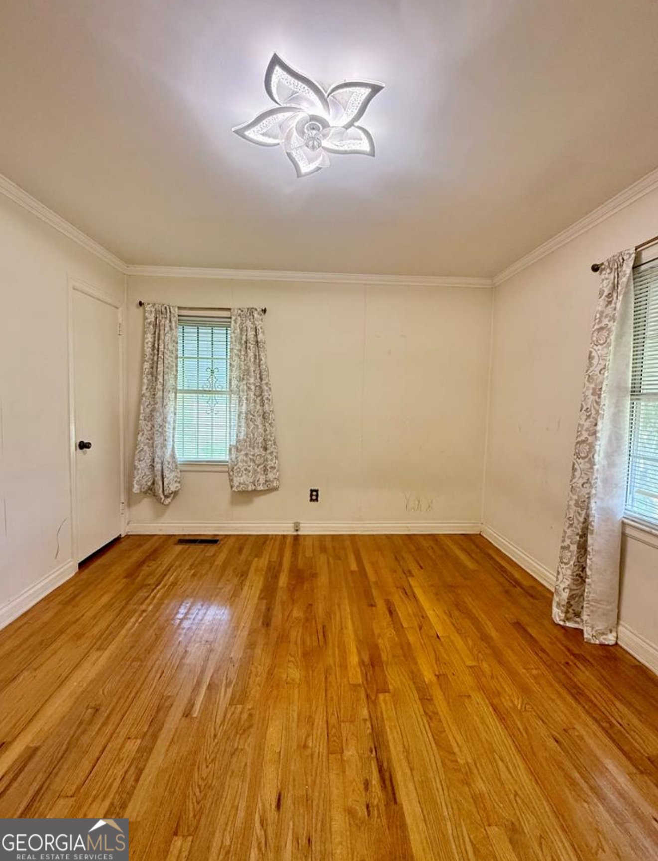 93 Arnall Boulevard Blakely, GA 39823 - Photo 29 of 43 wooden floor in an empty room with a window