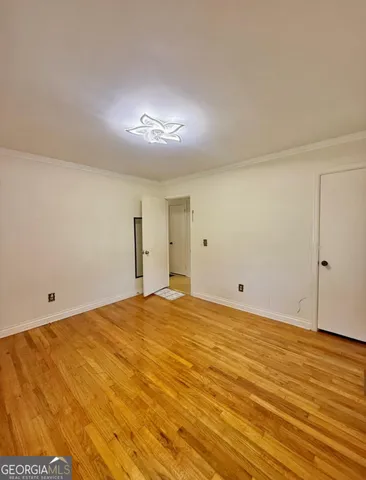 a view of a room with wooden floor and windows