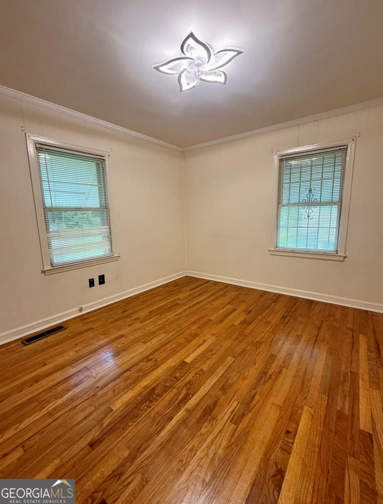 93 Arnall Boulevard Blakely, GA 39823 - Photo 35 of 43 a view of a room with wooden floor and chandelier