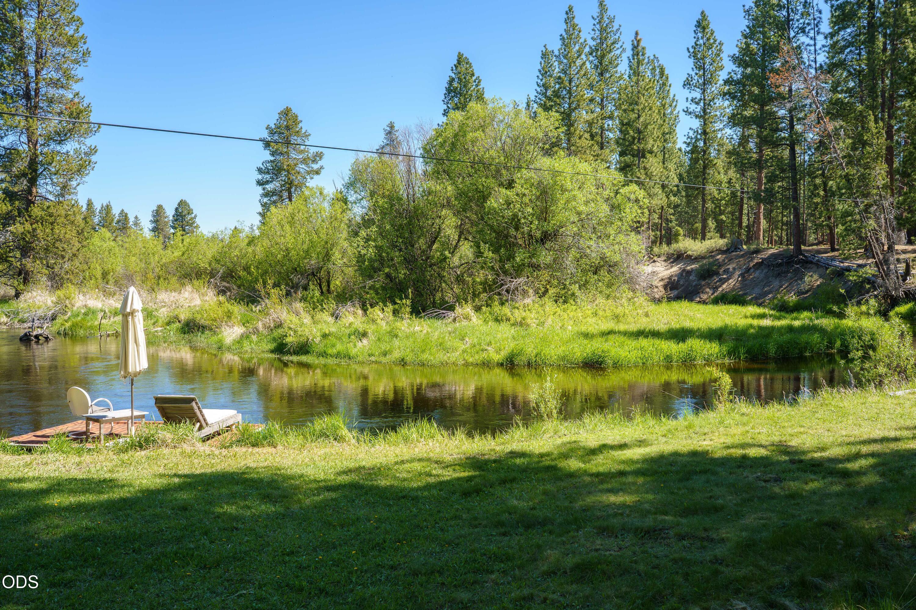 50910 Masten Road La Pine, OR 97739 - Photo 30 of 44 a backyard of a house with a yard and lake view