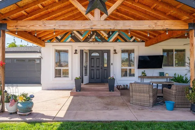 a kitchen with stainless steel appliances granite countertop a stove a sink dishwasher and a microwave oven with wooden cabinets