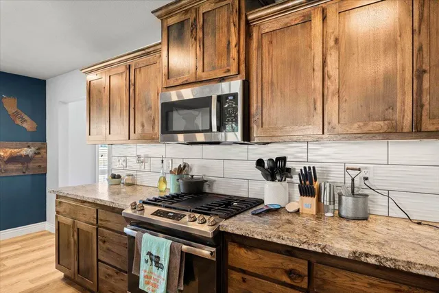 a view of a patio with table and chairs under an umbrella