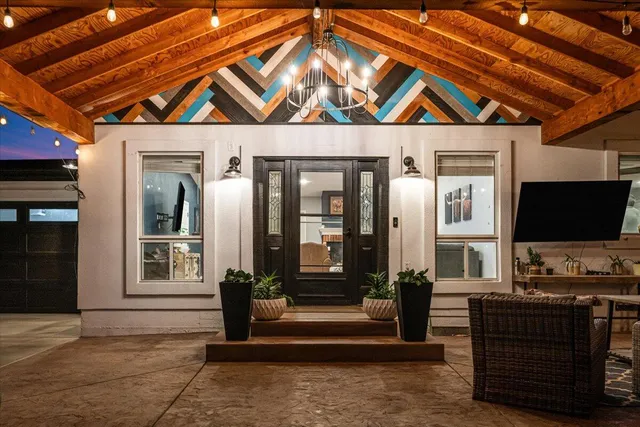 a view of patio with table and chairs and a big yard