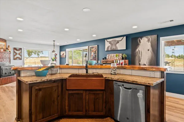 a living room with furniture a flat screen tv and a floor to ceiling window