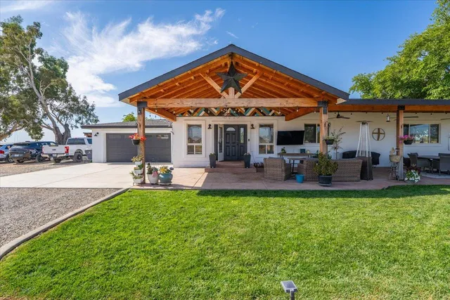 a view of a lake with outdoor seating area and trees in the background