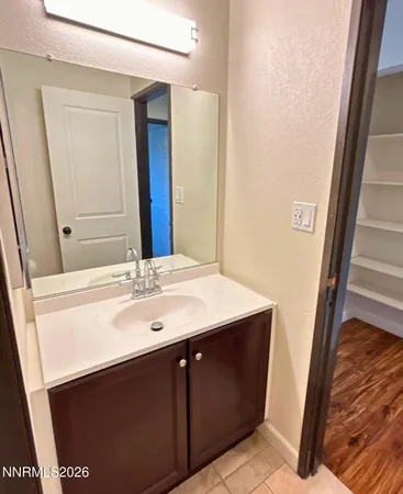 a bathroom with a sink a mirror and a vanity
