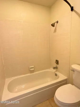 a bathroom with a toilet and bathtub