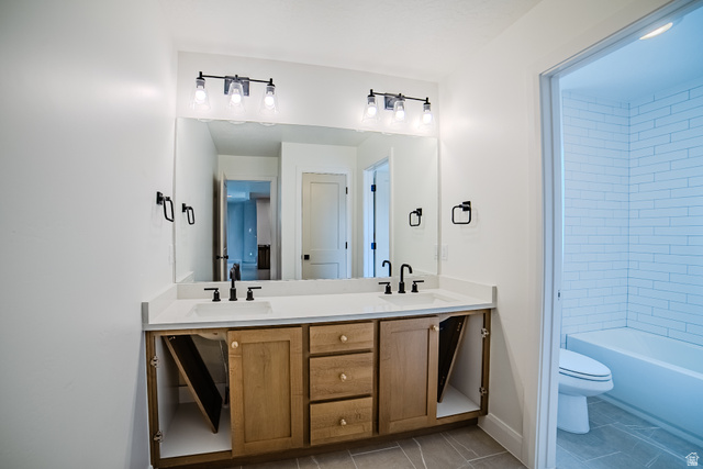 223 South Cottonwood Road, Unit 7501 Vineyard, UT 84059 - Photo 21 of 45 Double vanity featuring wood cabinetry, white countertops, and matte black fixtures