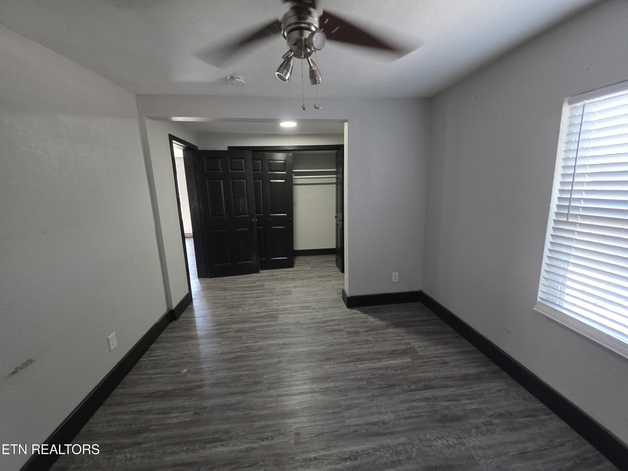 218 Burns Street Alcoa, TN 37701 - Photo 11 of 27 wooden floor in an empty room with a window