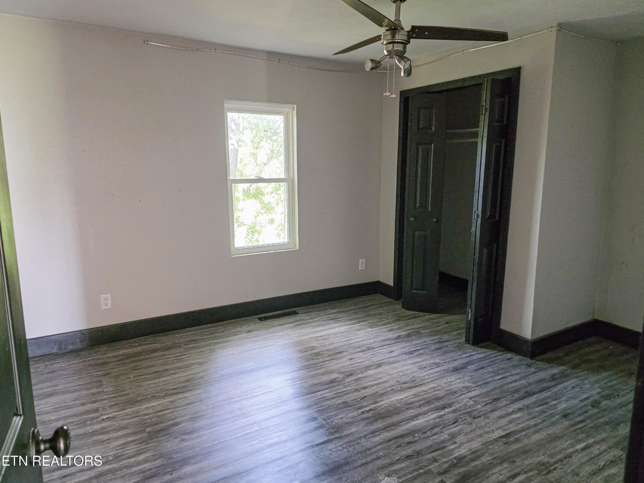 218 Burns Street Alcoa, TN 37701 - Photo 16 of 27 an empty room with wooden floor cabinet and windows