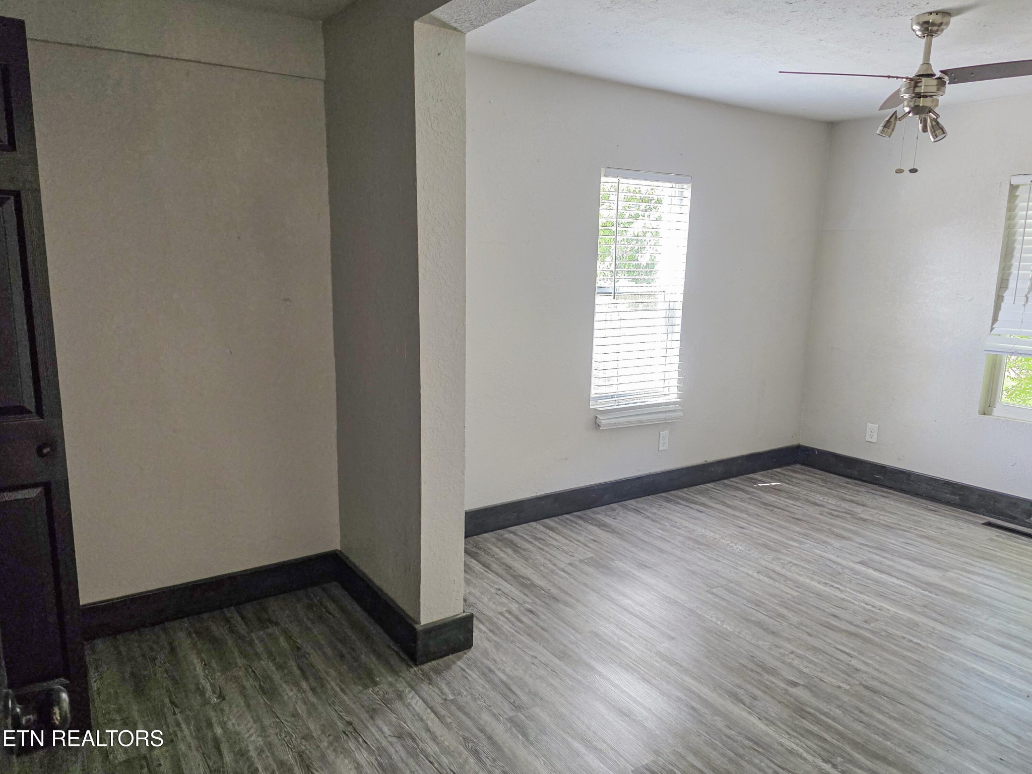 218 Burns Street Alcoa, TN 37701 - Photo 18 of 27 an empty room with wooden floor and windows