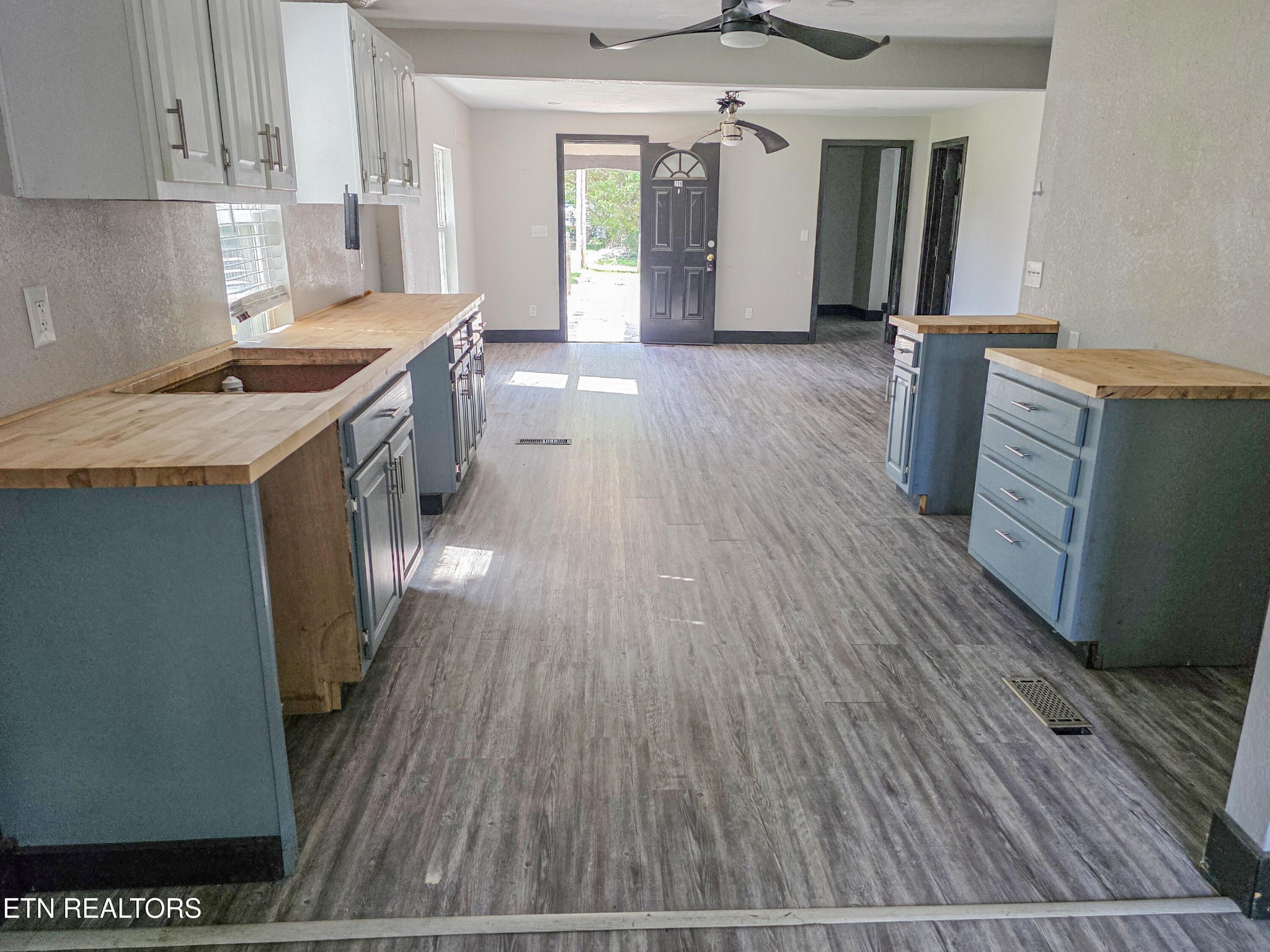 218 Burns Street Alcoa, TN 37701 - Photo 24 of 27 a kitchen with granite countertop a stove a sink and a refrigerator