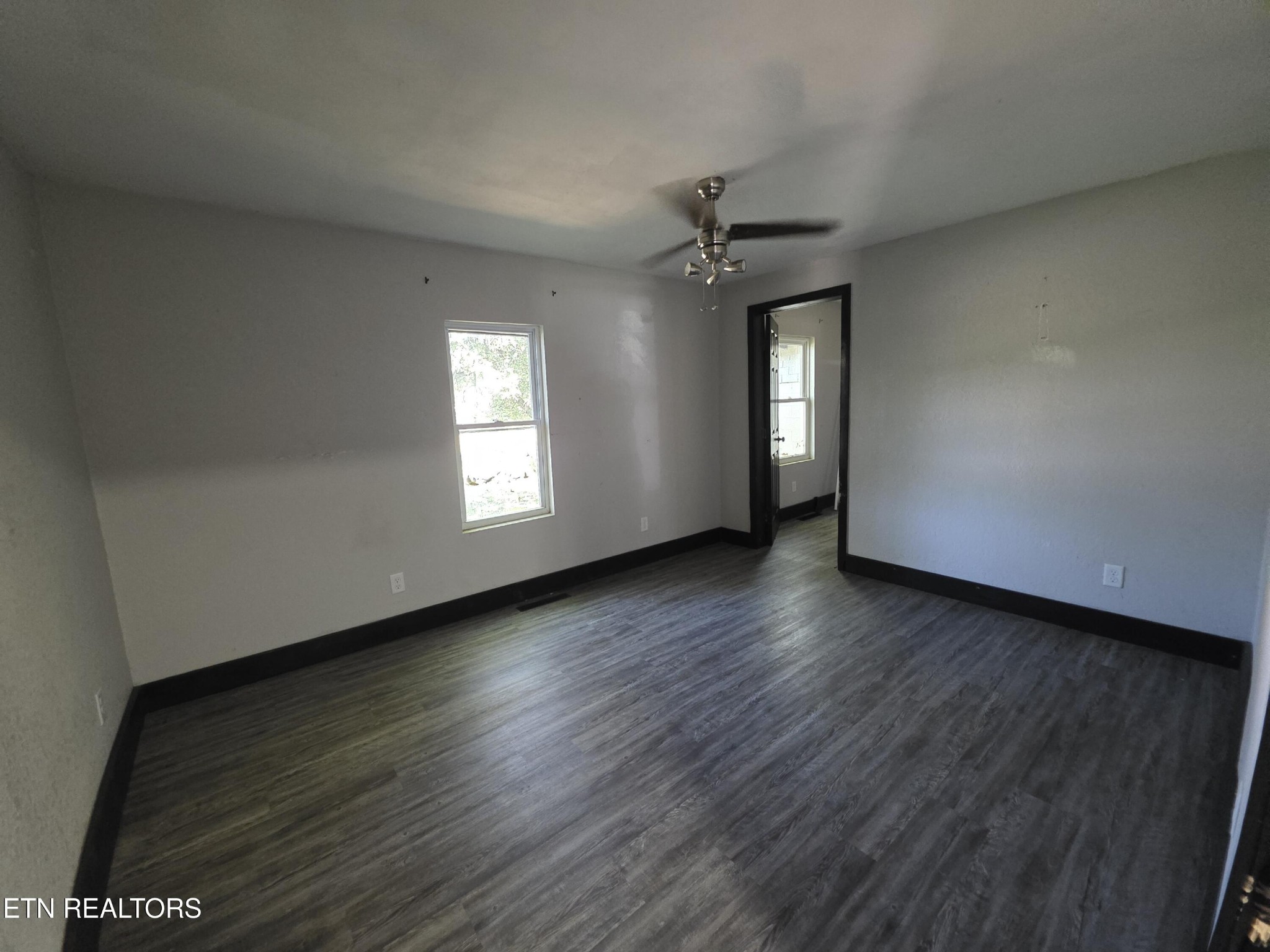218 Burns Street Alcoa, TN 37701 - Photo 3 of 27 an empty room with wooden floor and windows
