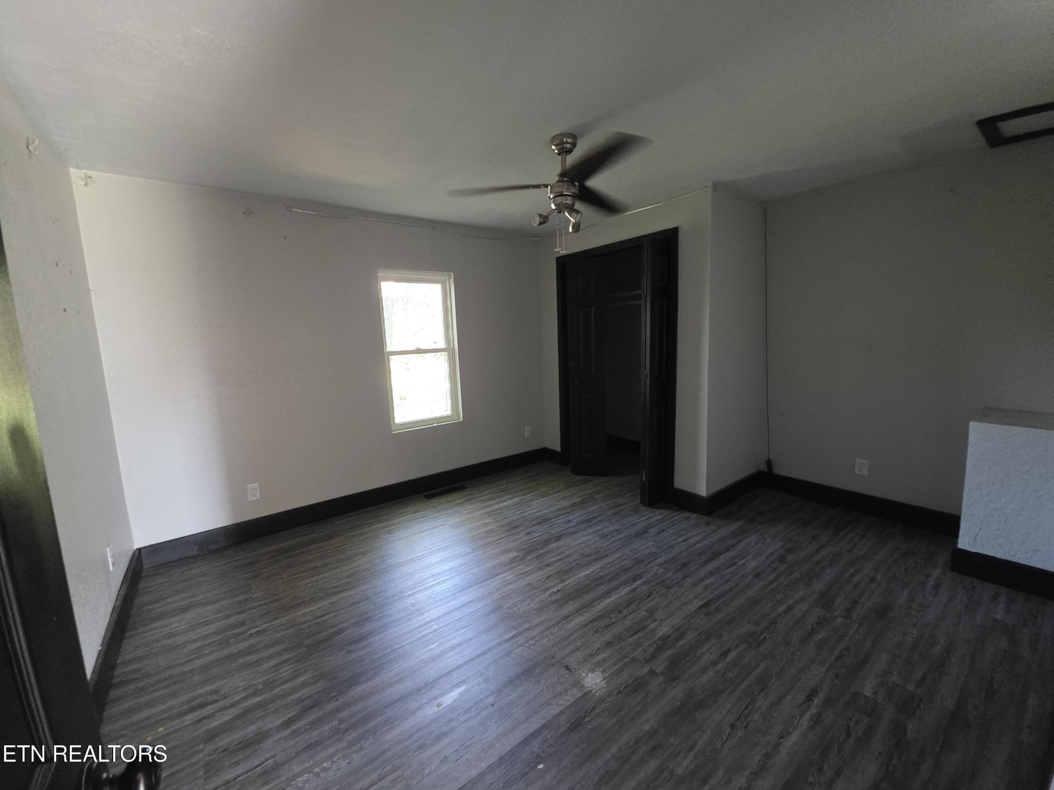 218 Burns Street Alcoa, TN 37701 - Photo 4 of 27 a view of empty room with wooden floor and fan