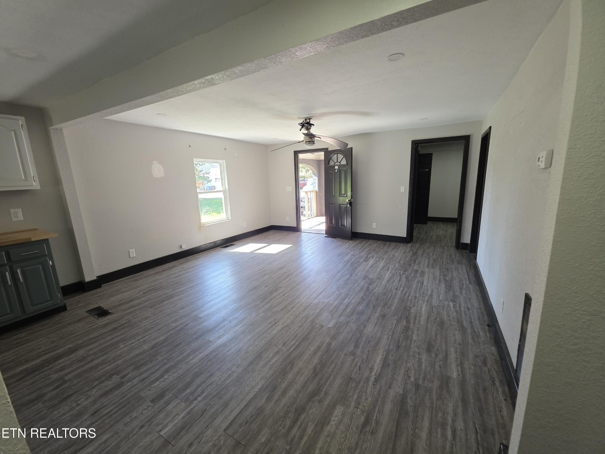 218 Burns Street Alcoa, TN 37701 - Photo 7 of 27 an empty room with wooden floor and windows