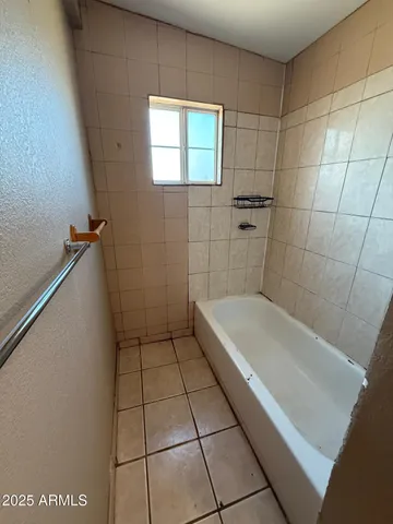a bathroom with a bathtub and shower