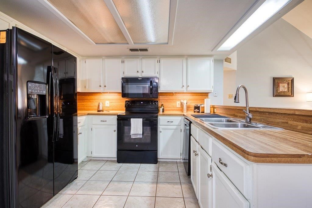 906 St Christopher Street Corpus Christi, TX 78418 - Photo 15 of 40 a kitchen with a sink stove and refrigerator