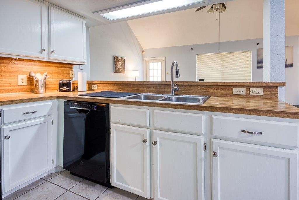 906 St Christopher Street Corpus Christi, TX 78418 - Photo 16 of 40 a kitchen with a sink stove and cabinets