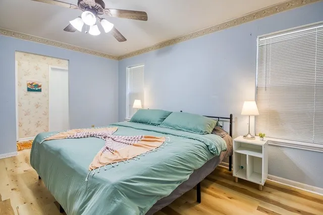 a bed sitting in a bedroom next to a window