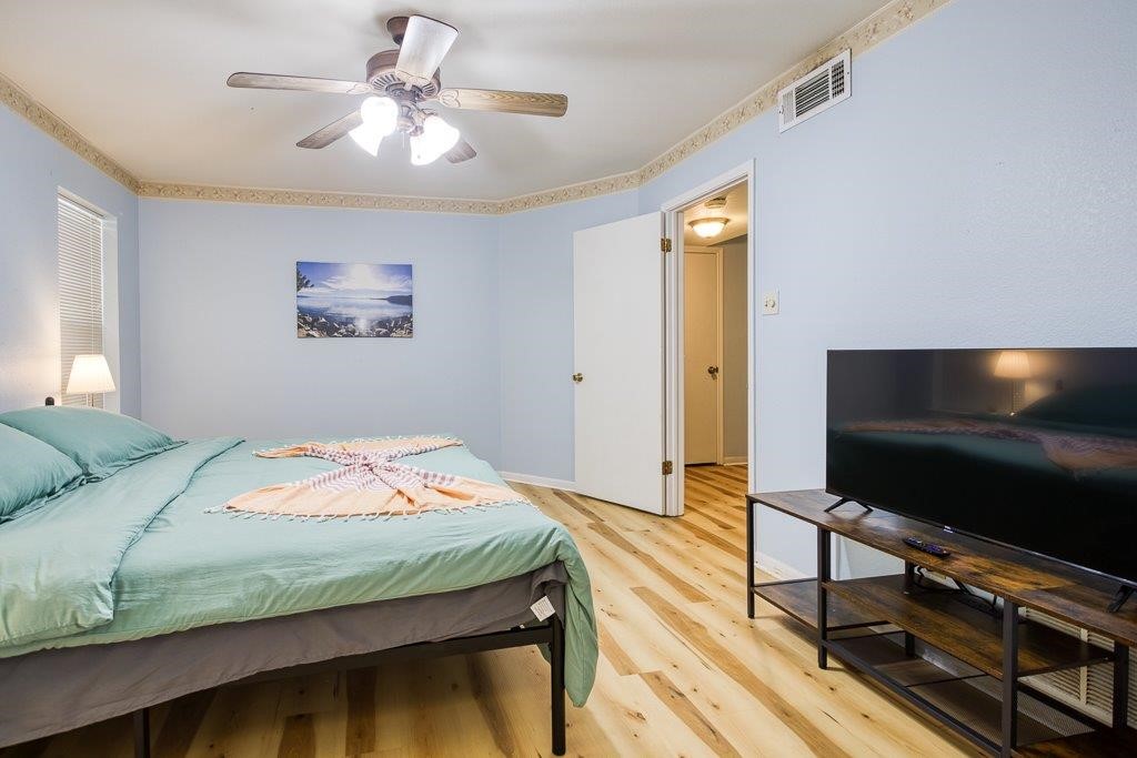 906 St Christopher Street Corpus Christi, TX 78418 - Photo 24 of 40 a bedroom with a bed and a flat screen tv