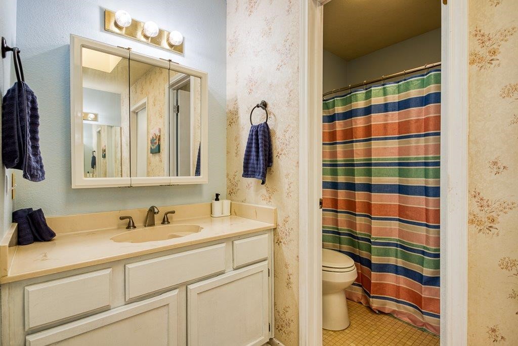 906 St Christopher Street Corpus Christi, TX 78418 - Photo 25 of 40 a bathroom with a sink and a mirror