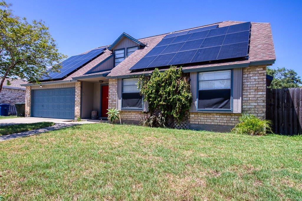 906 St Christopher Street Corpus Christi, TX 78418 - Photo 3 of 40 a front view of a house with garden