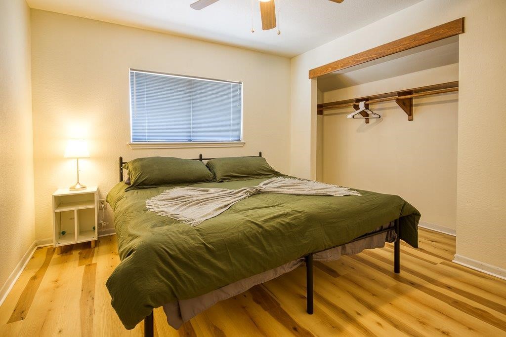 906 St Christopher Street Corpus Christi, TX 78418 - Photo 32 of 40 a bedroom with a bed and wooden floor