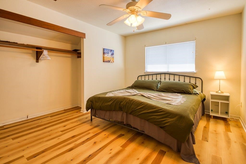 906 St Christopher Street Corpus Christi, TX 78418 - Photo 34 of 40 a bedroom with a bed and wooden floor