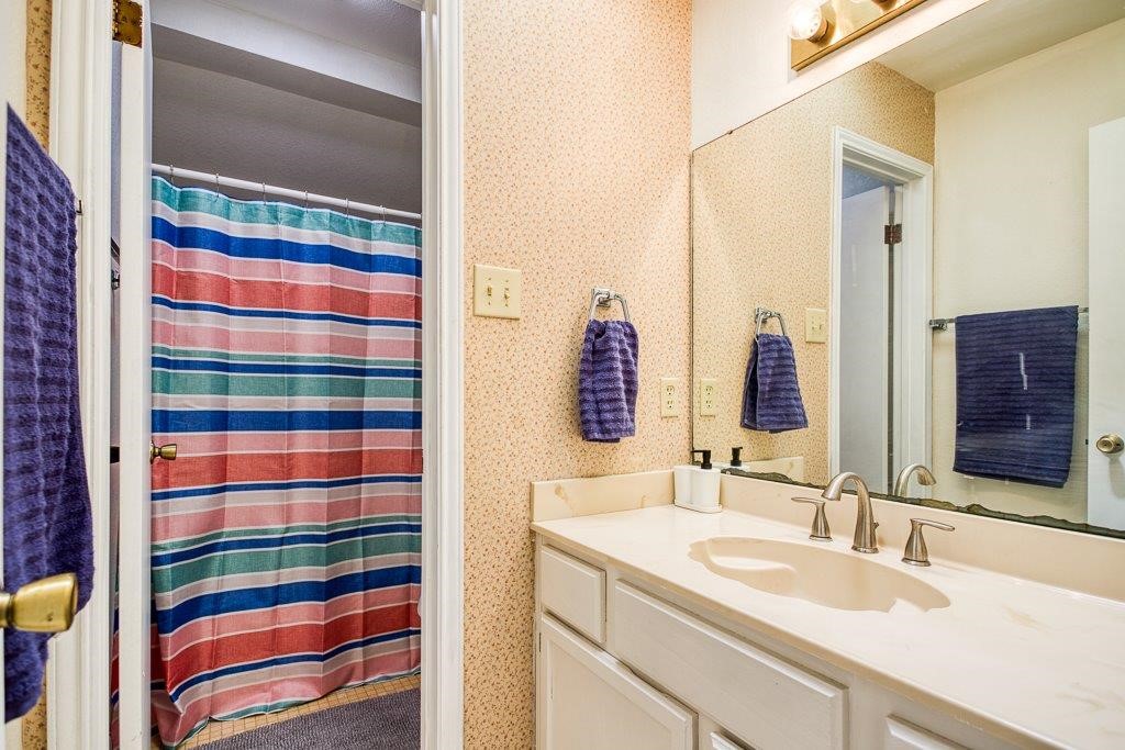 906 St Christopher Street Corpus Christi, TX 78418 - Photo 36 of 40 a bathroom with a sink and a mirror