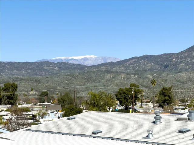 a view of a town with mountains in the background