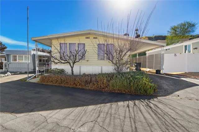 a view of a patio with table and chairs barbeque potted plants and large tree