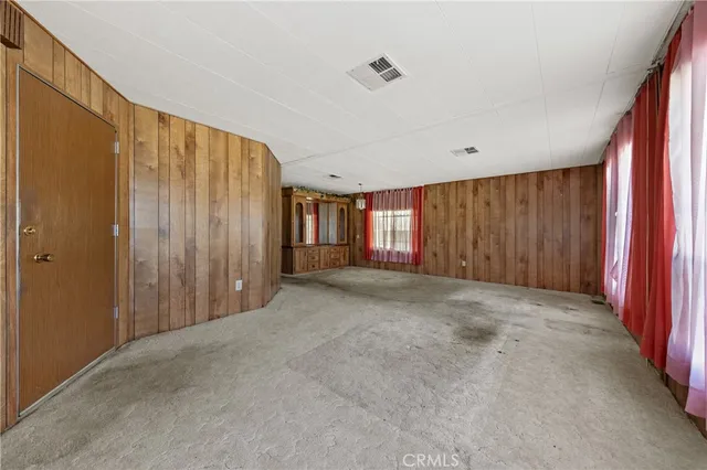 a view of an empty room with wooden walls
