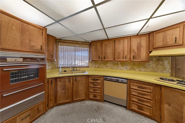 a kitchen with sink cabinets and window