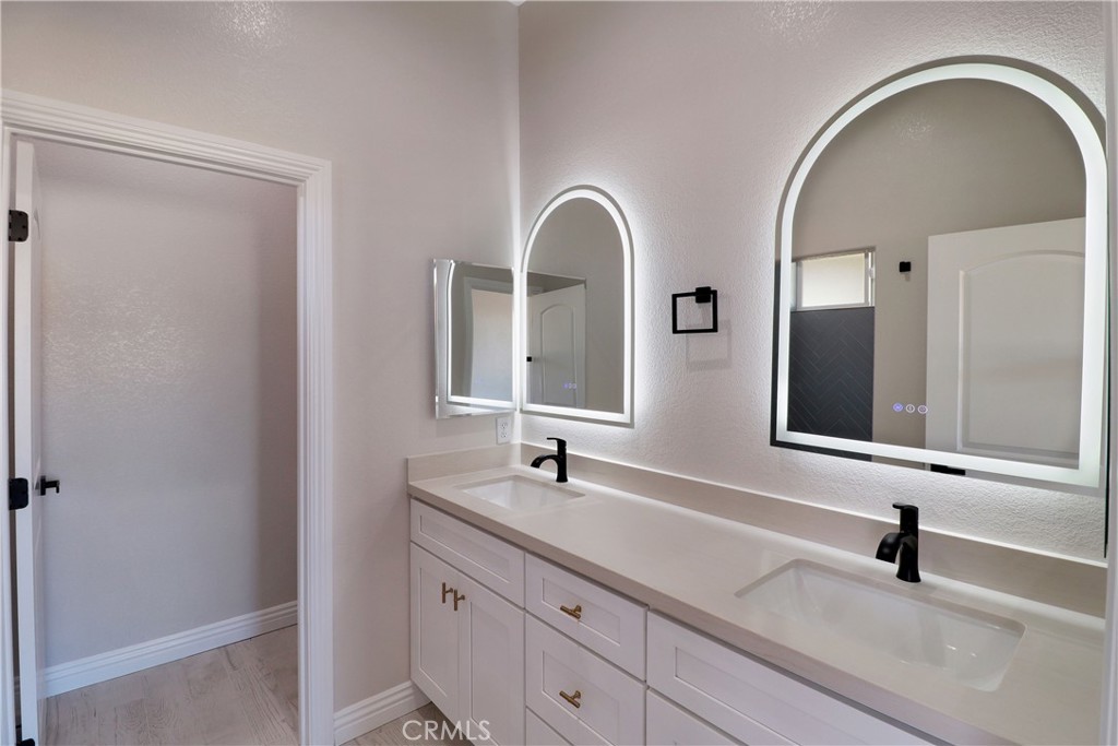 14785 Tigertail Road Apple Valley, CA 92307 - Photo 10 of 20 a bathroom with a double vanity sink and a mirror